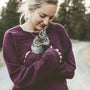 selective focus photography of woman hugging gray kitten