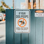 if your dog pops you scoop signage on gray wall