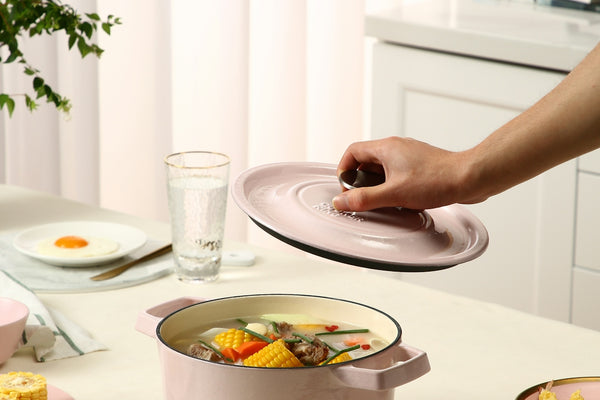 person holding white ceramic plate with sliced fruits