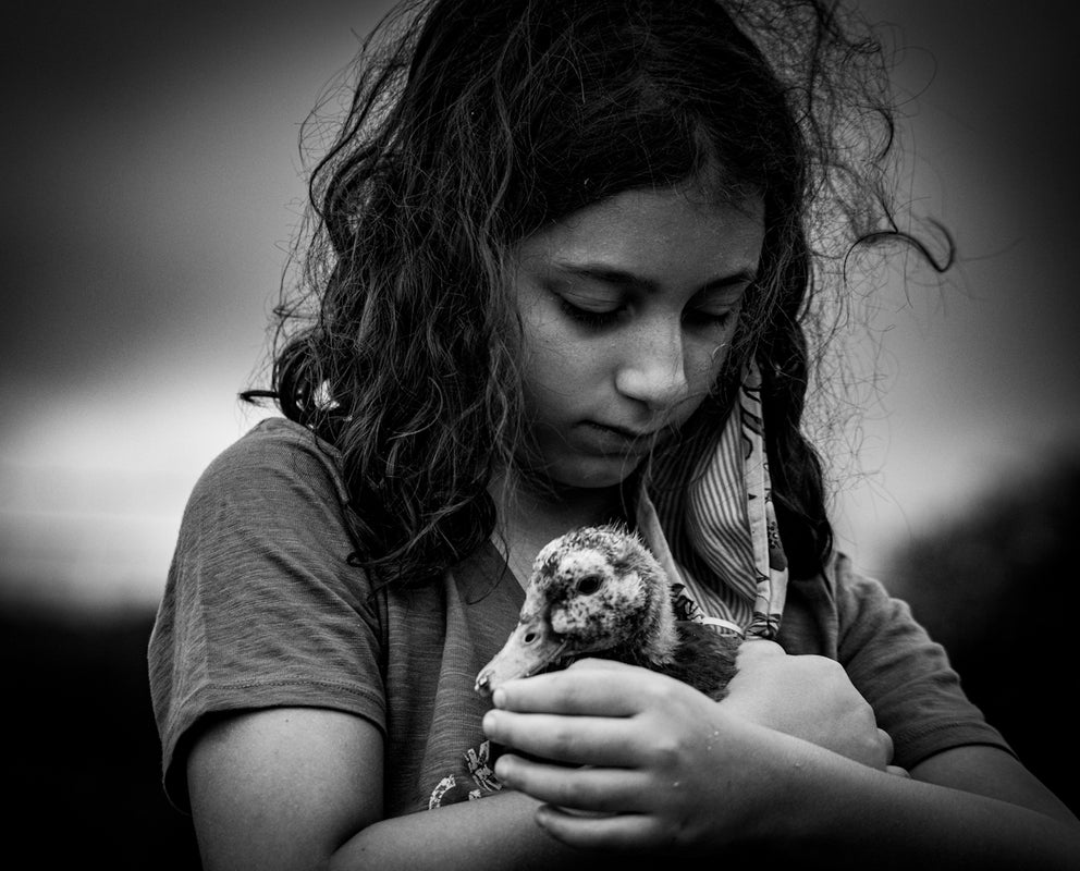 grayscale photo of woman holding dog