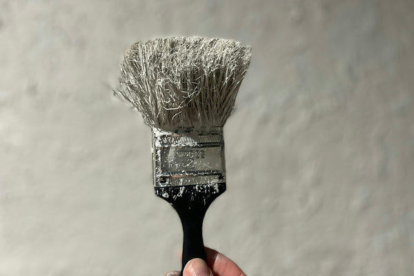 person holding black and white brush