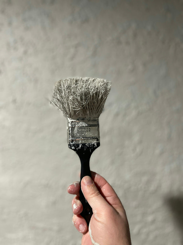 person holding black and white brush