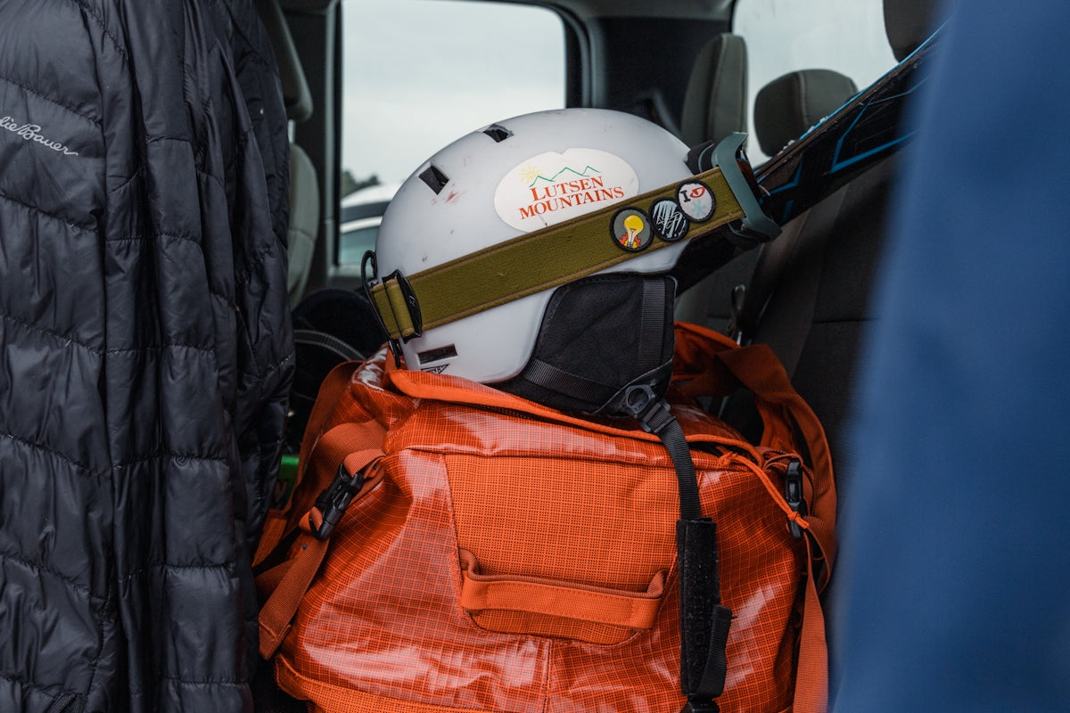 a helmet on top of a backpack in the back of a truck