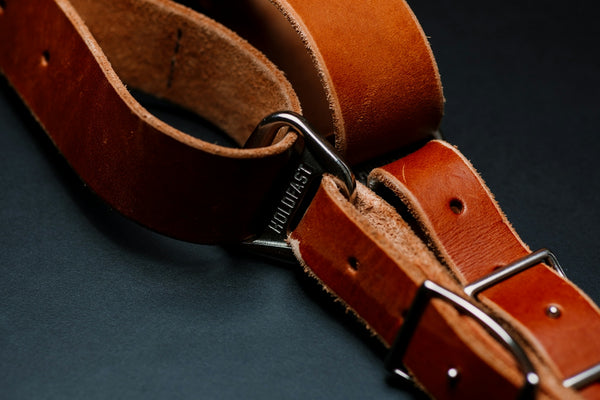 a pair of leather straps on a black surface