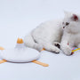 a cat lying on a plate with a toy