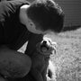 a person kissing a dog