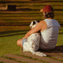 a person and a dog sitting on grass