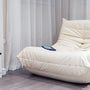 a white bed with a white curtain
