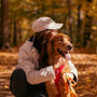 a woman kneeling down with a dog in her lap