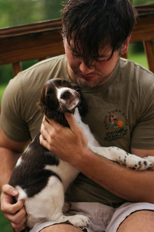 A man sitting on a bench holding a dog