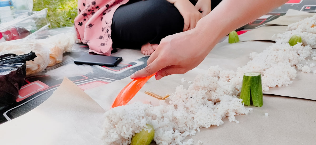 A woman is cutting carrots on a table