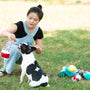 Woman plays with her dog in a grassy field.