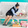 Woman and dog play with toys.
