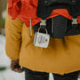 selective focus photograph of person wearing orange coat and black backpack