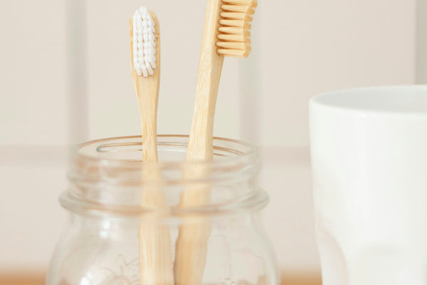 two brown wooden toothbrushes