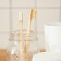 two brown wooden toothbrushes