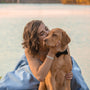 woman kissing dog