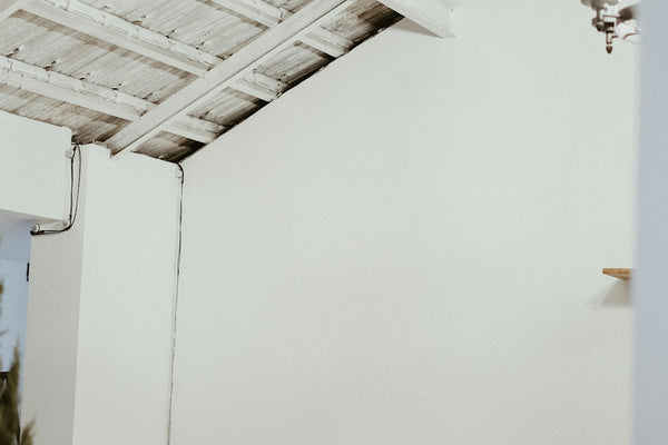 a bed with a white comforter and a wooden headboard