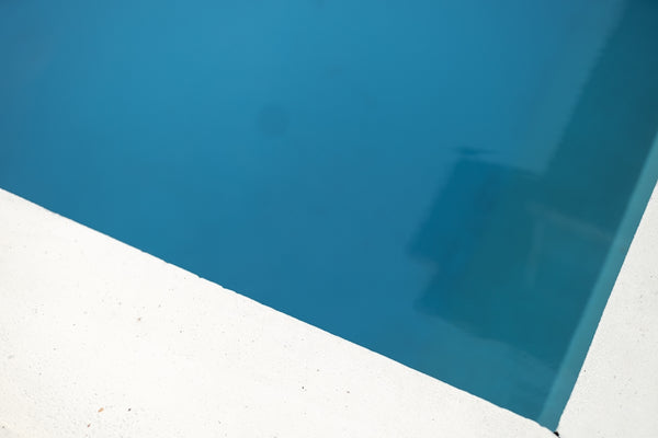 black textile near blue wall