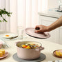 person holding white ceramic plate with sliced fruits