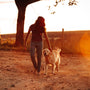 woman in black shirt and white short holding yellow labrador retriever