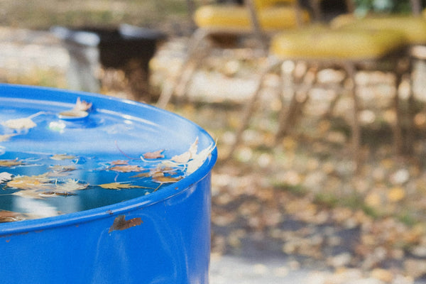 blue plastic bucket on brown wooden table