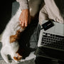 person in gray long sleeve shirt holding white and orange cat