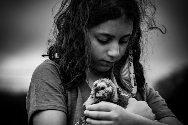 grayscale photo of woman holding dog