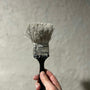 person holding black and white brush