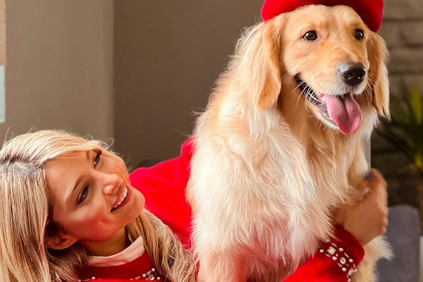 a woman sitting on a couch with a dog
