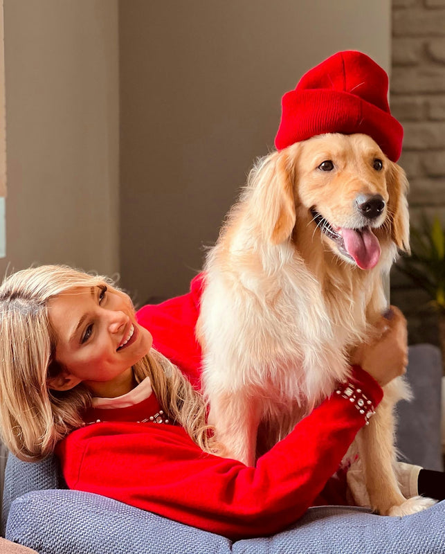 a woman sitting on a couch with a dog