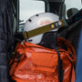 a helmet on top of a backpack in the back of a truck