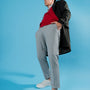 a man in a red shirt and grey pants