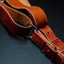 a pair of leather straps on a black surface