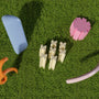 a group of toys laying on top of a lush green field