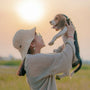 a woman holding a small dog up to her face