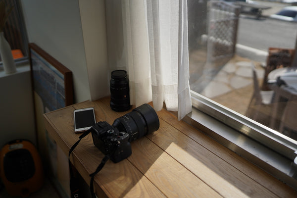 a camera sitting on a table next to a window