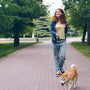 a woman walking a dog on a brick path