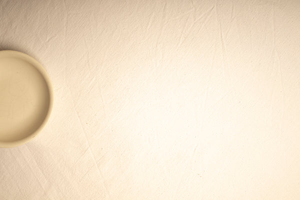 A blurry photo of a white wall with a light on it