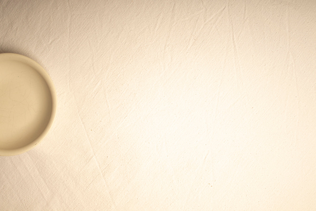 A blurry photo of a white wall with a light on it