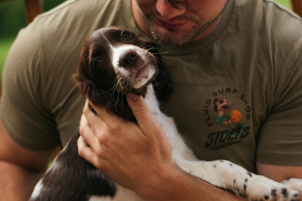 A man sitting on a bench holding a dog