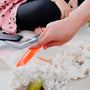A woman is cutting carrots on a table