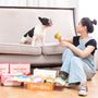 A woman and her dog enjoying treats.