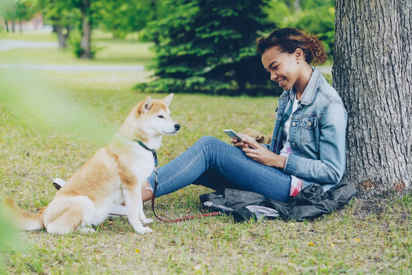 Woman and her dog enjoying time in the park.