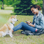 Woman and her dog enjoying time in the park.